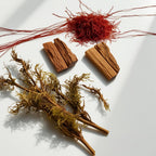 Saffron, moss and wood representing the olfactory notes of the perfume.
